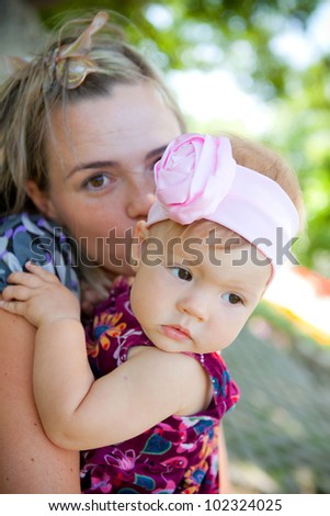 Happy young mother with her baby in park