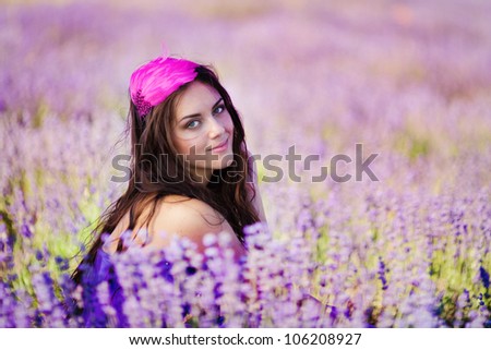 Close up portrait of a beautiful woman on a lavender field at summer