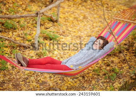 Woman lying in a hammock in the forest