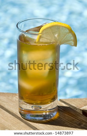 Tall Glass of Ice Tea by the Swimming Pool