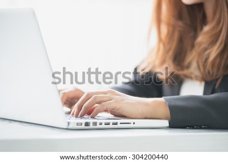 close up hand of young asia woman working with notebook in the office