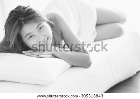 smile asia Beautiful young woman in white bathrobe in bedroom at home, black and white