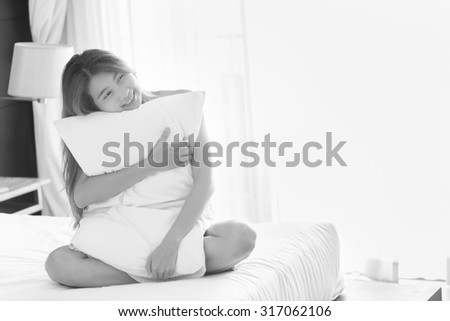 asia young sexy woman in white towel hug Pillow sit on bed in bedroom at home, black and white
