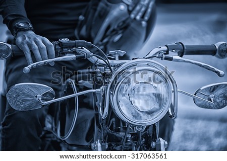 the Biker man sitting on his motorcycle, vintage effect