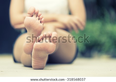 asia woman sitting on  floor. Feet close up. vintage effect