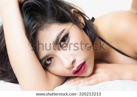 close up Asia women face lying on bed in room, beauty concept