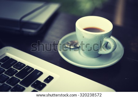working time. hot coffee, espesso with laptop on wood teble. business concept