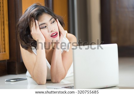 Asia office woman lying on floor with open laptop at home, vintage effect