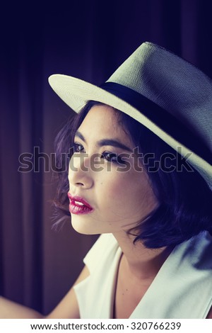 head shot of asia woman with hat in room, beauty concept, vintage style