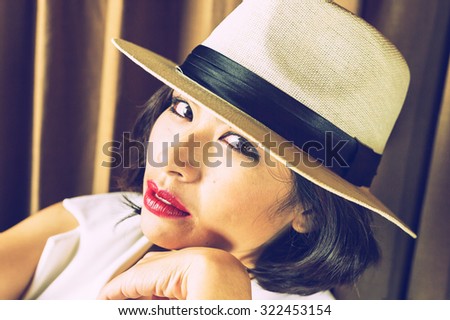 head shot of asia woman with hat in room, beauty concept, vintage effect
