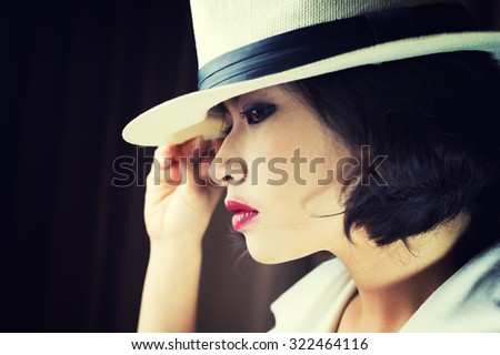 head shot of asia woman with hat in room, beauty concept, vintage style