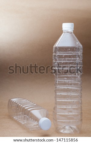 recycle plastic water bottle on recycle paper background