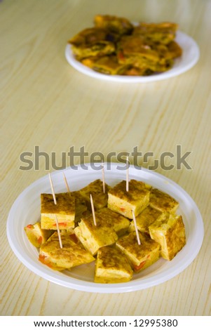 Spanish omelet with a white plastic plate
