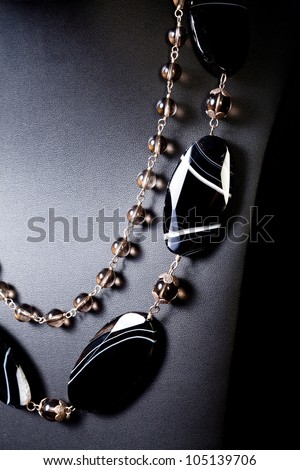 luxury jewelry pearl and black set necklace over black background
