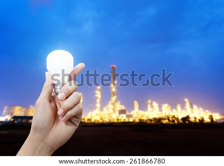 Light energy for industry, Hand holding light bulb in industrial topic