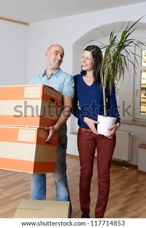 young couple moves the house