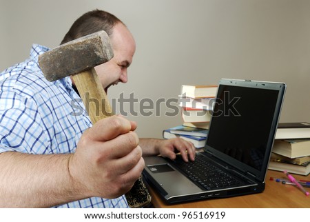 angry man is about to smash his computer