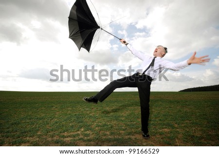 goth guy in business clothes fights with his umbrella