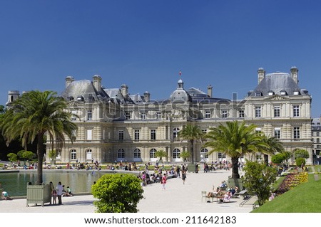 PARIS - JULY 2: People enjoy sunny day in the Luxembourg Garden on July 2, 2014 in Paris. Luxembourg Palace is the official residence of the President of the French Senate.