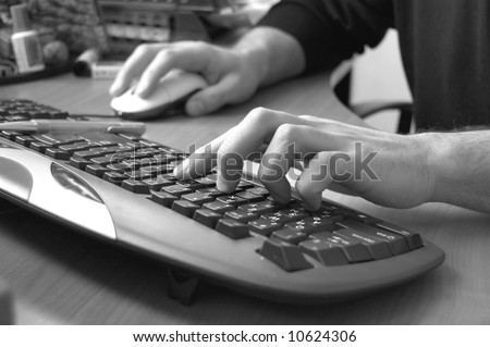 male hand typing on keyboard, black and white