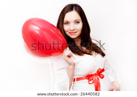 Pregnant woman with heart shaped balloon
