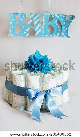 Diaper cake for a baby shower in blue tones for boy