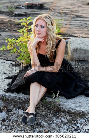 Glamour woman in black ballerina dress outdoor looking aside