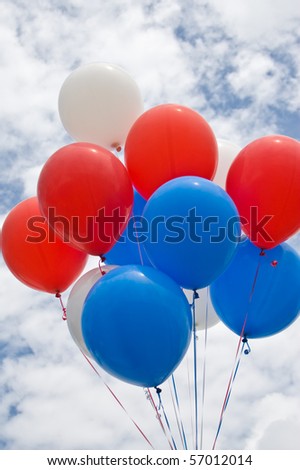 Colorful Balloons On A Cloudy Day In Red, White and Blue