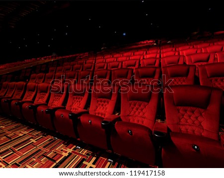 Red arm chair in dark theater