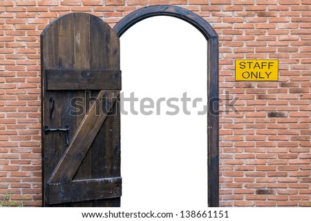 vintage door with brick wall and staff only sign with empty copy space inside the door