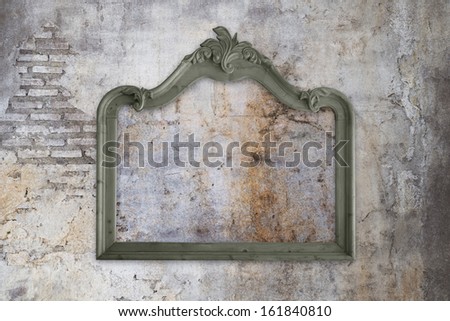 Vintage wooden frame on concrete old wall with cracks