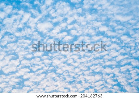 sky with tiny silhouette of plain in the lower left corner