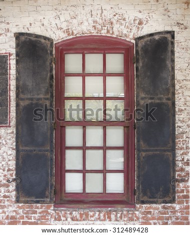 metal window barn door on brick wall