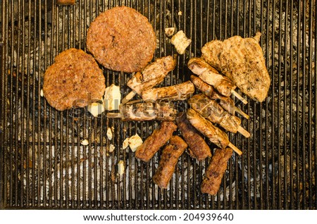 Grilling the meat and cheese on metal grill - bird\'s eye view