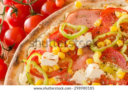 Pizza with paprika, feta, cherry tomato corn and ham - Birds eye view