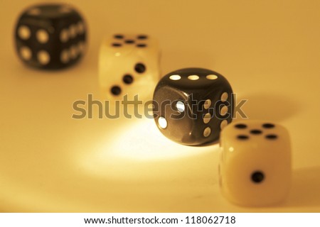 pin lighted black dice and another black and two white dices sitting in a line