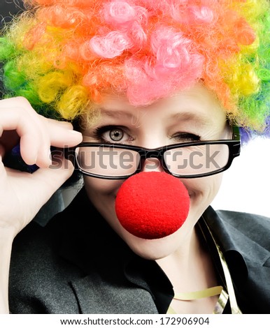 Attractive woman with clown nose and wig winking at the camera