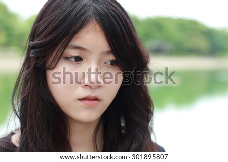 Portrait of thai student teen beautiful girl Black Dresses relax in park.