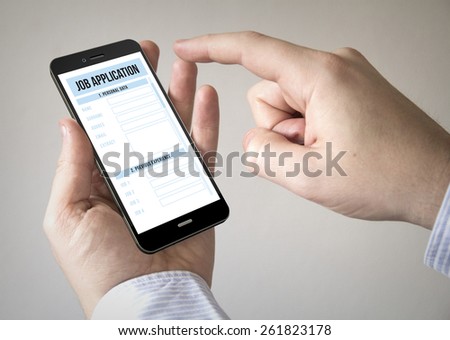 Close up of man using mobile smart phone with online job application on the screen