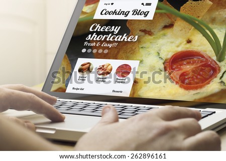 surfing the internet concept: man using a laptop with cooking website on the screen