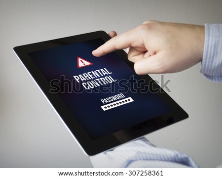 new technologies concept: hands with touchscreen tablet with parental control on the screen. Screen graphics are made up.
