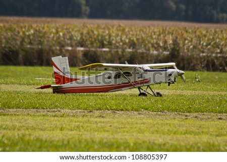 Radio controlled model airplane in a field ready for take-off.