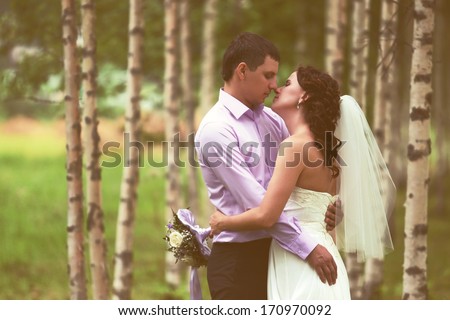 Loving couple. The groom and the bride in love embraces.