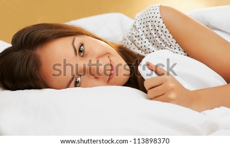 beautiful girl sleeps in the white bedroom