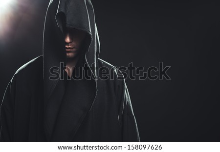 Portrait of a Man in a black robe on a dark background