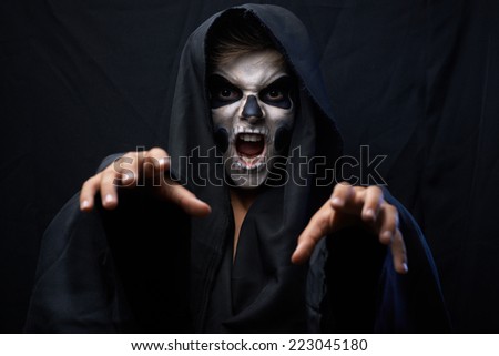 Teen with makeup skull cape wants to grab
