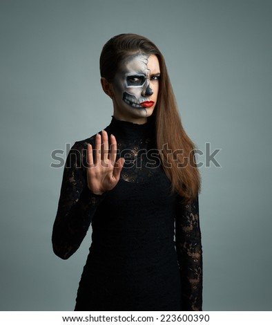 beautiful woman with make-up skeleton refuses