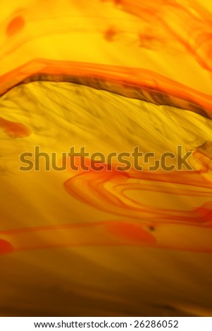 Abstract design of orange and red swirls in glass. It is possible to be used as a background.