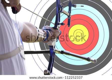 An archer drawing a bow with archery target background. (clipping path)