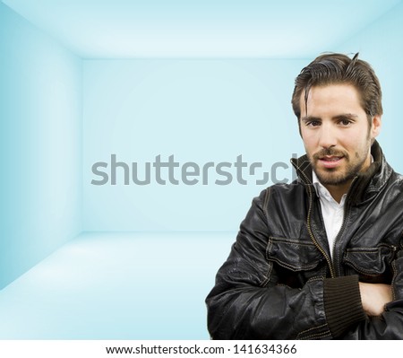 young handsome man smiling in an empty room to place your object